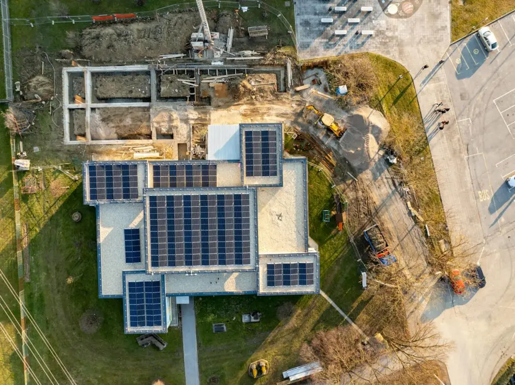 Top-down view of a building with solar panels and construction work in progress.